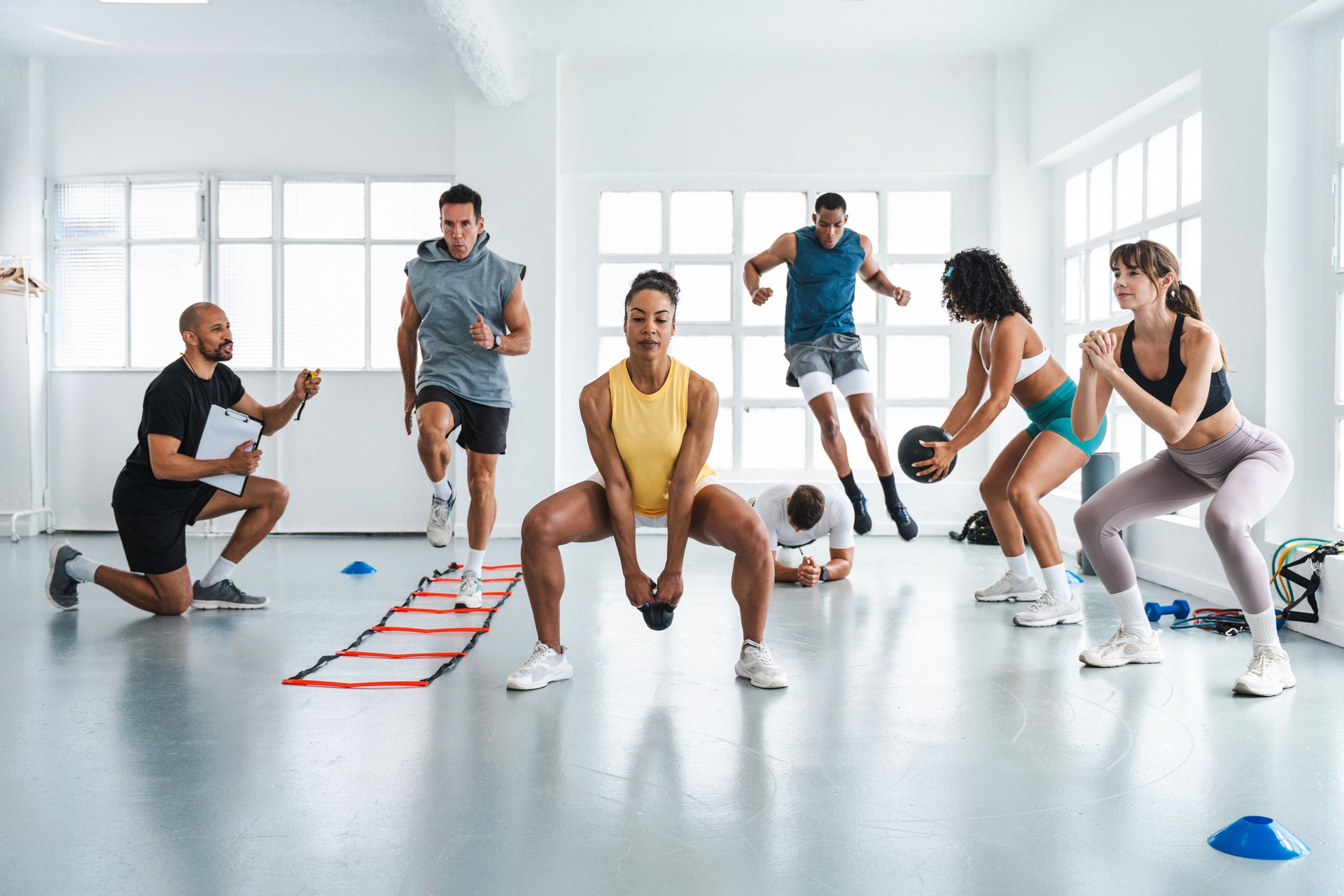 Athletes doing functional training workout with personal trainer