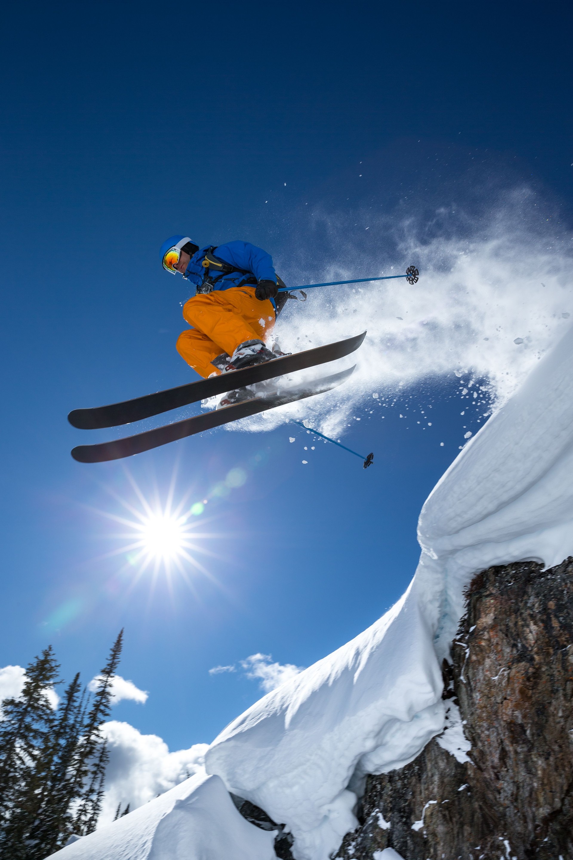Person jumping off the mountain in extreme skiing